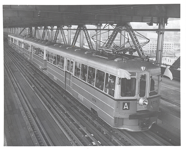 In 1958, the capacity of the Oakland Bay Bridge was reduced by removing these trains and tracks. Now AC Transit bus riders sit in traffic jams with everyone else. Photo: Transbay Joint Powers.