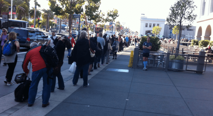During rush hour, the line for SF ferry services run well out of the terminal and down the Embarcadero. Photo: WETA