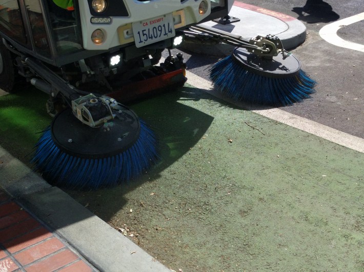 The operator can move these brushes, which propel dirt and debris into a vacuum scoop under the truck, back and forth.