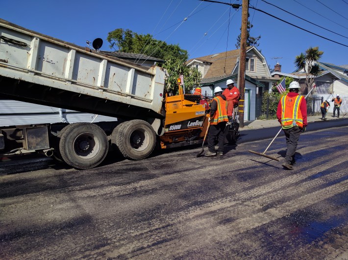 A dump truck loads asphalt into the new spreader purchased by Oakland. Photo: Streetsblog/Rudick