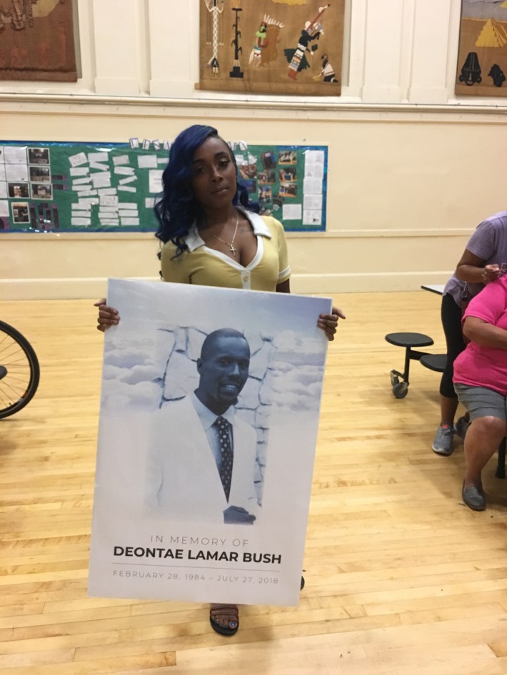 Cherie McCullom holds a photo of her brother Deontae.