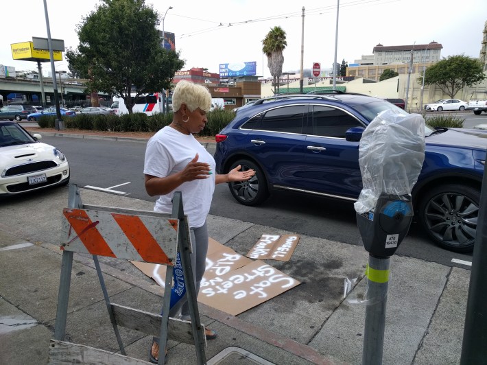 This woman parked in the travel lane, ripped off the "no stopping" sign, and parked on the cardboard shrine