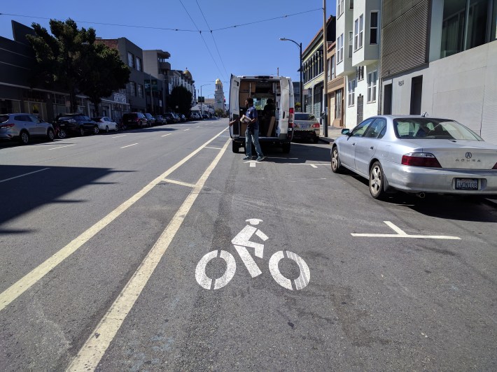 A delivery truck blocking the unprotected bike lane on Howard.