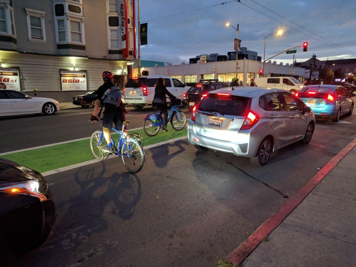 Cyclists attempting to navigate the mixing zone at the intersection of 9th and Howard