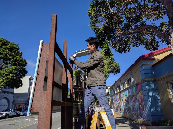 The Exploratorium's Colin Wang busy doing maintenance on the parklet