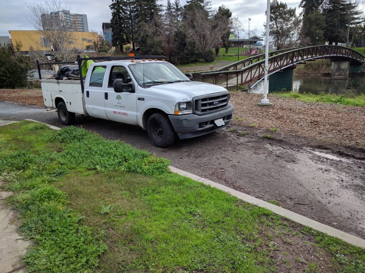 The crew, after the collected some of the trash, stopped to access the ponding/draingage problems. Photo: Streetsblog/Rudick