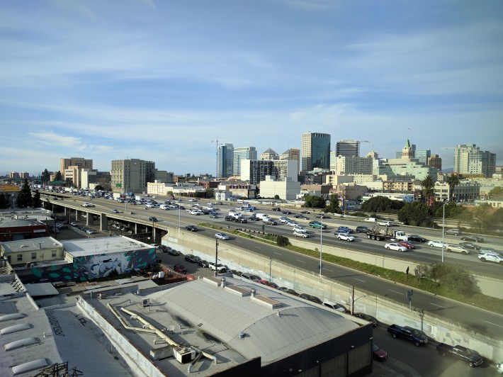 The Nimtz Freeway, its frontage roads, and a whole lot of parking cuts Oakland up, but we worry about scooters? Photo: Streetsblog/Rudick