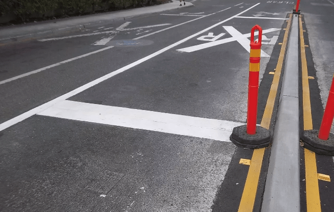 Concrete divider and new paint at the crossing on Churchill Ave. in Palo Alto, where Caltrain had a vehicle strike last year and two in 2017. Photo: Caltrain