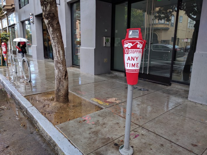 SFMTA seems to have done a better job of keeping people from parking on the bike lane by covering the meters with these bags