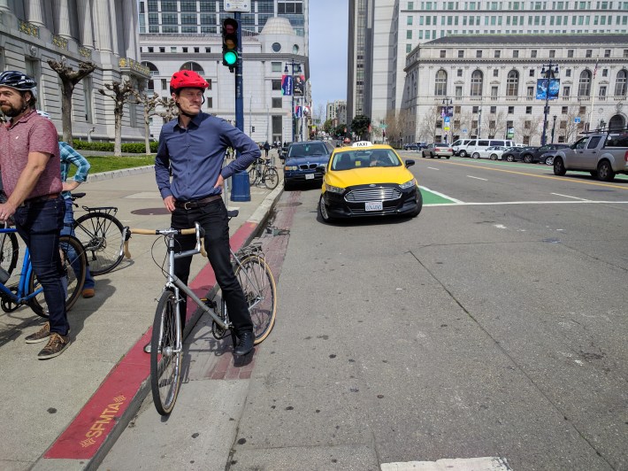 Scott Fay, who has been hit himself, in front of City Hall--with a cab parked on the unprotected bike lane on Polk