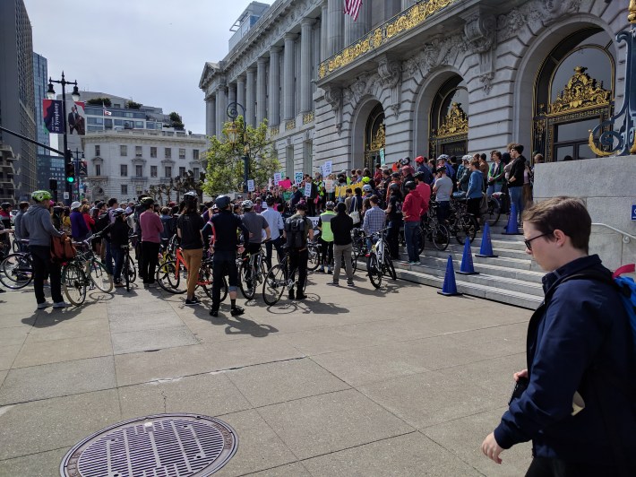 Some 200 advocates came to the steps of City Hall this afternoon to demand protected bike lanes