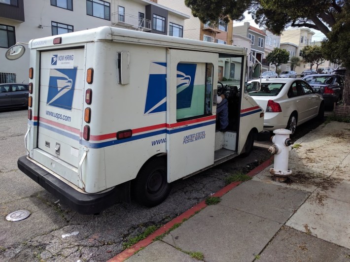 An illegally parked mail truck blocks sightlines at a corner near the Richmond Senior Center. Photo: Streetsblog/Rudick