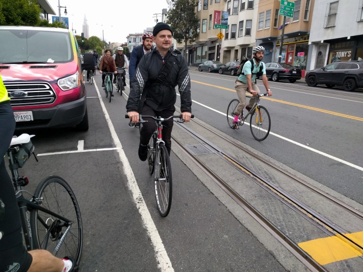 It was hazardous cycling the narrow band of asphalt between the rails and parked cars on Columbus