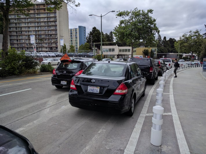 An Uber/Lyft picked up a passenger on the far side of the parking lane--so no bike lane blocked for a change