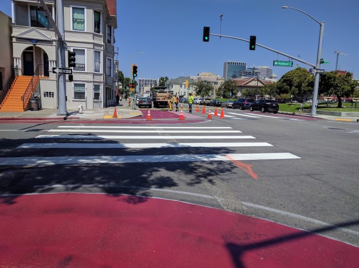 Post-and-paint bulbouts, with bicycle cut throughs, going in at Madison and 8th