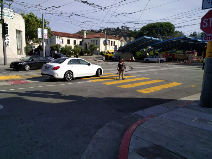 Even when this disabled woman was crossing the street, this motorist was unchallenged when making a left turn and blocking the crosswalk (right in front of SFMTA officers).