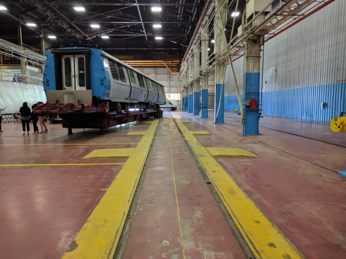 Tracks embedded in the factory floor. However, even these are useless for making BART trains, thanks to BART's non-standard gauge wheels and track