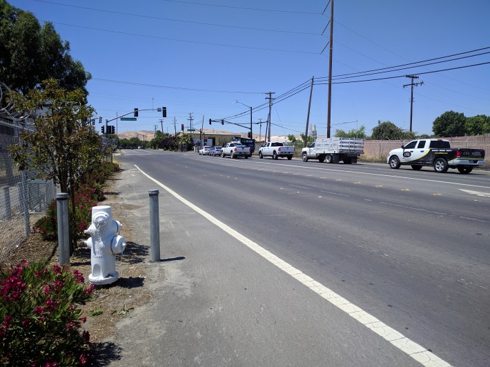 Loveridge road, near the factory entrance, doesn't have much love for bicycle, scooters, or pedestrians