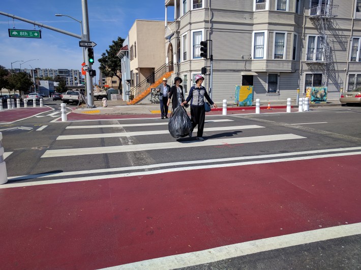 With shorter crossing distances and motorist forced to slow around turns, it's just easier to cross the street thanks to these protected intersections...done by Oakland DOT. But they do require some compromises with motorists. Photo: Streetsblog/Rudick