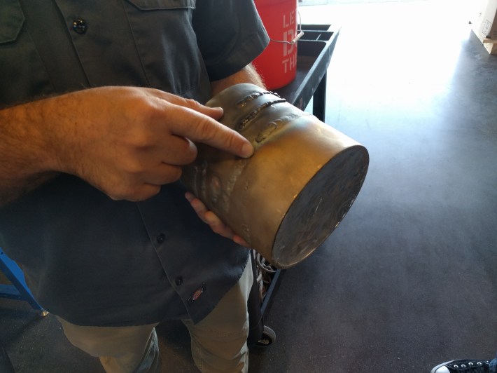 Welders practice on scraps of pipe