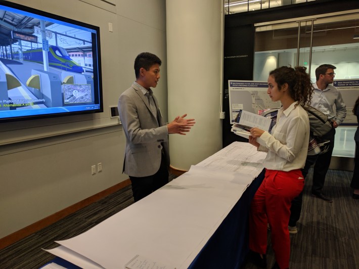 James Tung tries to convince Farah Soltane that the trains are fast enough under the current plan. Photo: Streetsblog/Rudick