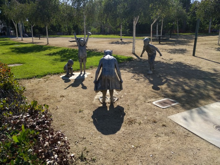 Sculptures of children, and other art work commemorating native peoples and wildlife, adorn the river at regular intervals