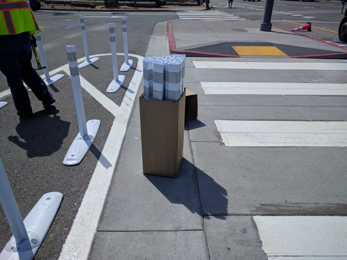 Crews were adding plastic posts at crosswalks and the few driveways along the route