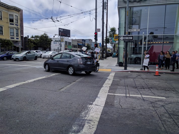 Almost to highlight the dangerous conditions, this Prius very nearly right-hooked a cyclists at the protest location