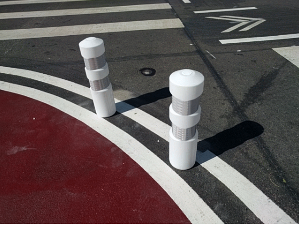 The protected intersections around Lake Merritt use more robust-looking bollards on the edge of the turn, not withdrawn with a buffer that still invites motorists to make fast, careless turns