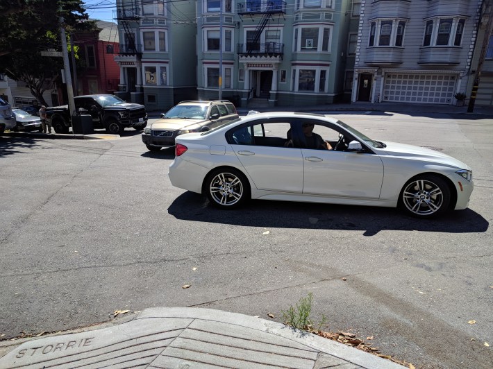 The numskull in this BMW started to turn right onto Storrie, and then suddenly changed directions and backed up the opposite side of the street instead to get a parking spot