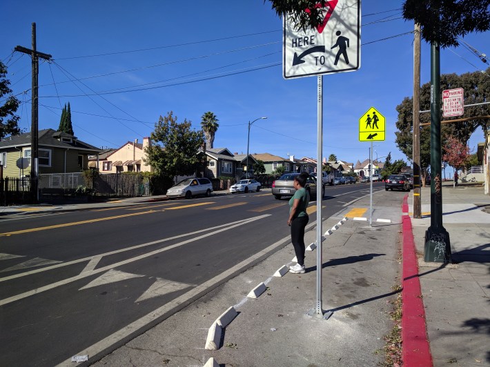The blocks also allowed OakDOT to place the crosswalk signs in the street, to make them more visible
