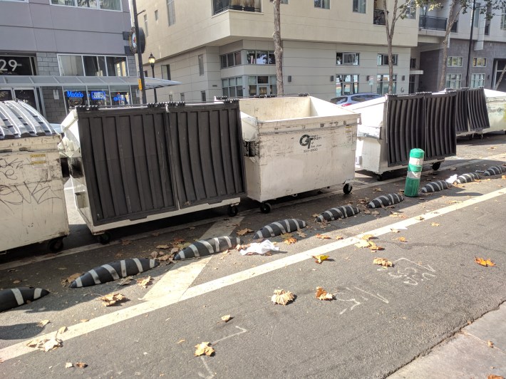 These concrete blocks keep garbage dumpsters out of the bike lane
