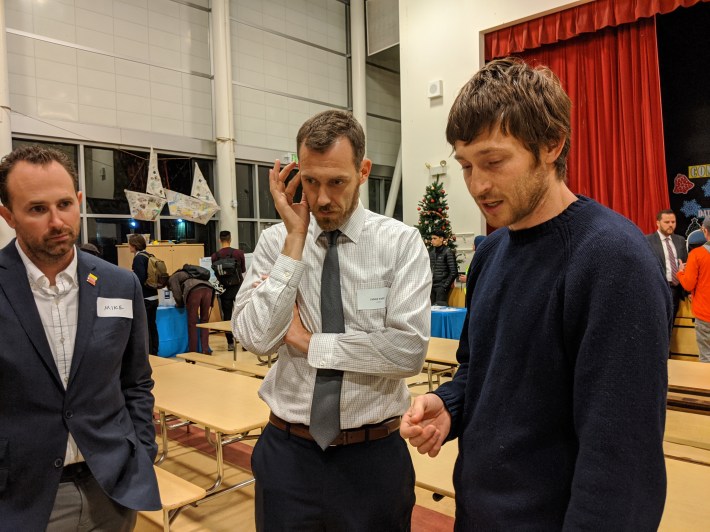 SFMTA's Jaime Parks (white shirt) and People Protected Bike lane advocate Matt Brezina, commenting on the poor intersection design, at last night's meeting.