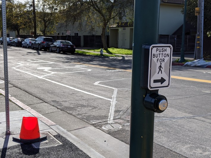 embedded sensors start the traffic signal cycling for cars. Bikes just have to wait or dismount and push a button.