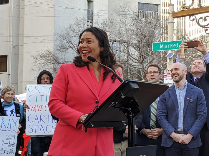 Mayor London Breed in the foreground. Malcolm Heinicke and BRian Wiedenmeier behind her left shoulder