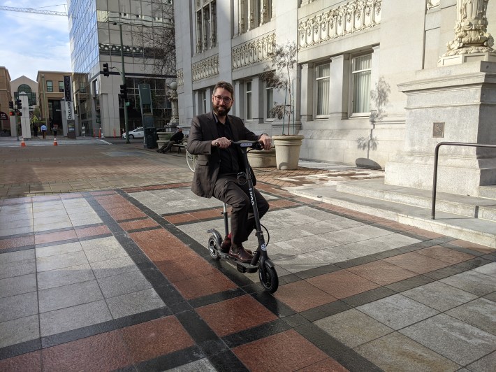 Oakland spokesperson Sean Maher took the scooter on a little spin in front of city hall