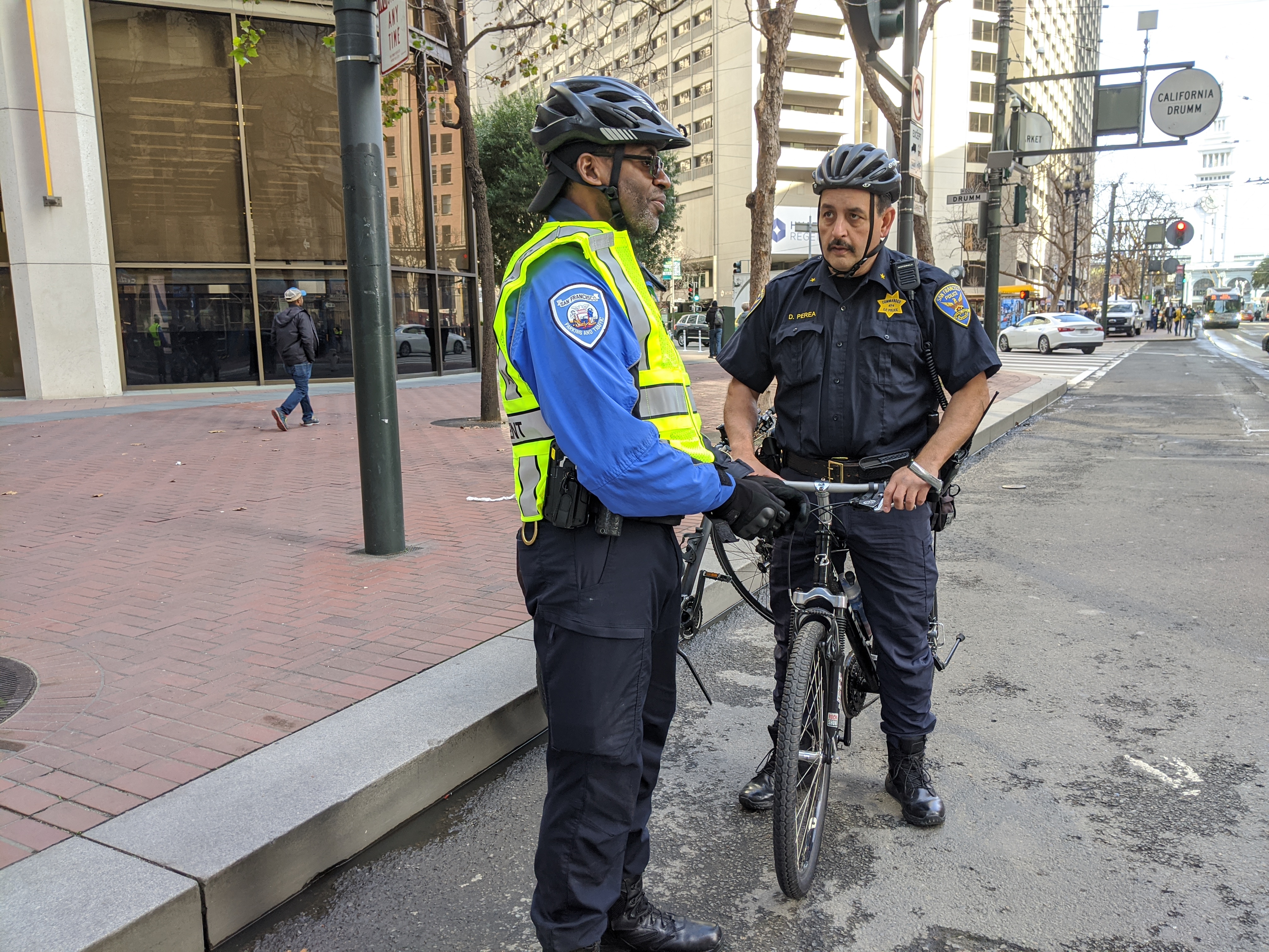 Commander Daniel Perea checking in with an SFMTA enforcement officer on the opening day of 'car-free' Market Street. Photo: Streetsblog/Rudick