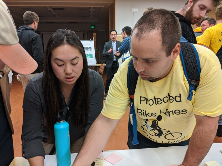 SFMTA engineer Winnie Lee and advocate Bruce Halperin discussing protected intersections at yesterday's open house. Photo: Streetsblog/Rudick