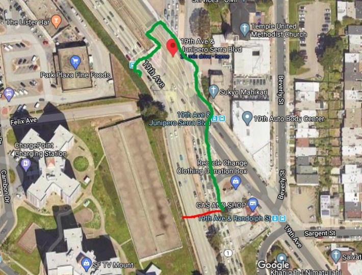 The green line gives an idea of what's involved with trying to cross this intersection. The red line shows the most direct path across the intersection from the gas station. Image: Google Maps