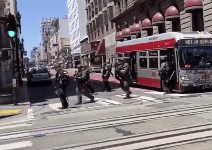 A still from a video posted June 1 of a chartered Muni bus offloading cops in riot gear.