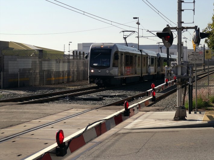 Even Los Angeles has gates that preempt cross traffic on much of its light-rail system, seen here in Pasadena. Photo: LA Metro