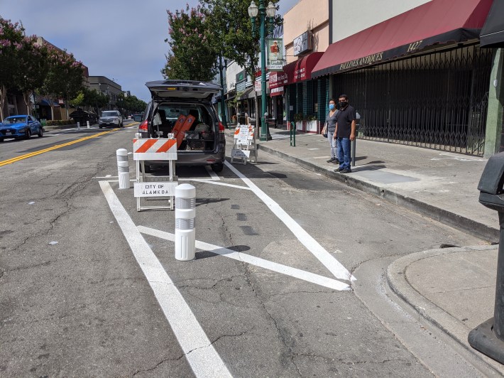 Converting these dining areas to protected bike lanes will take another step or two. Photo: Streetsblog/Rudick