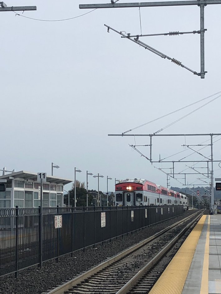 Caltrain running under new cantenary poles in 2019. Hayden Clarkin's twitter feed