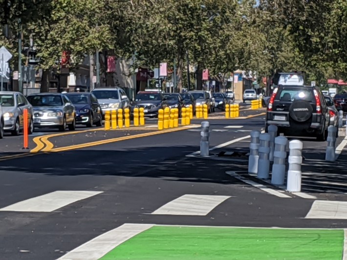 Yellow bollards denote a crosswalk