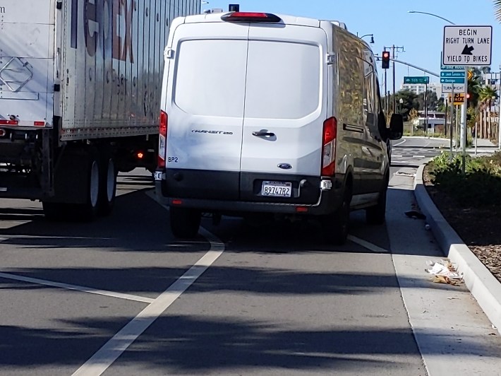 One of the "mixing zone" intersections just outside of the Brooklyn Basin development, with cars driving illegally on the bike lane