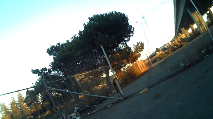 The cut through in the fence under the freeway. Still from a rear facing bike camera. Photo: Streetsblog/Rudick