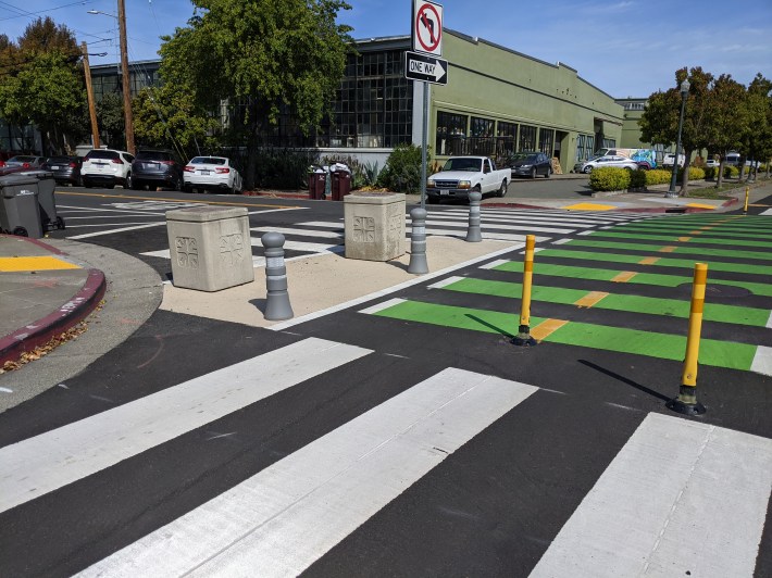 Emeryville used a combination of old concrete garbage cans and concrete colored plastic posts on Doyle