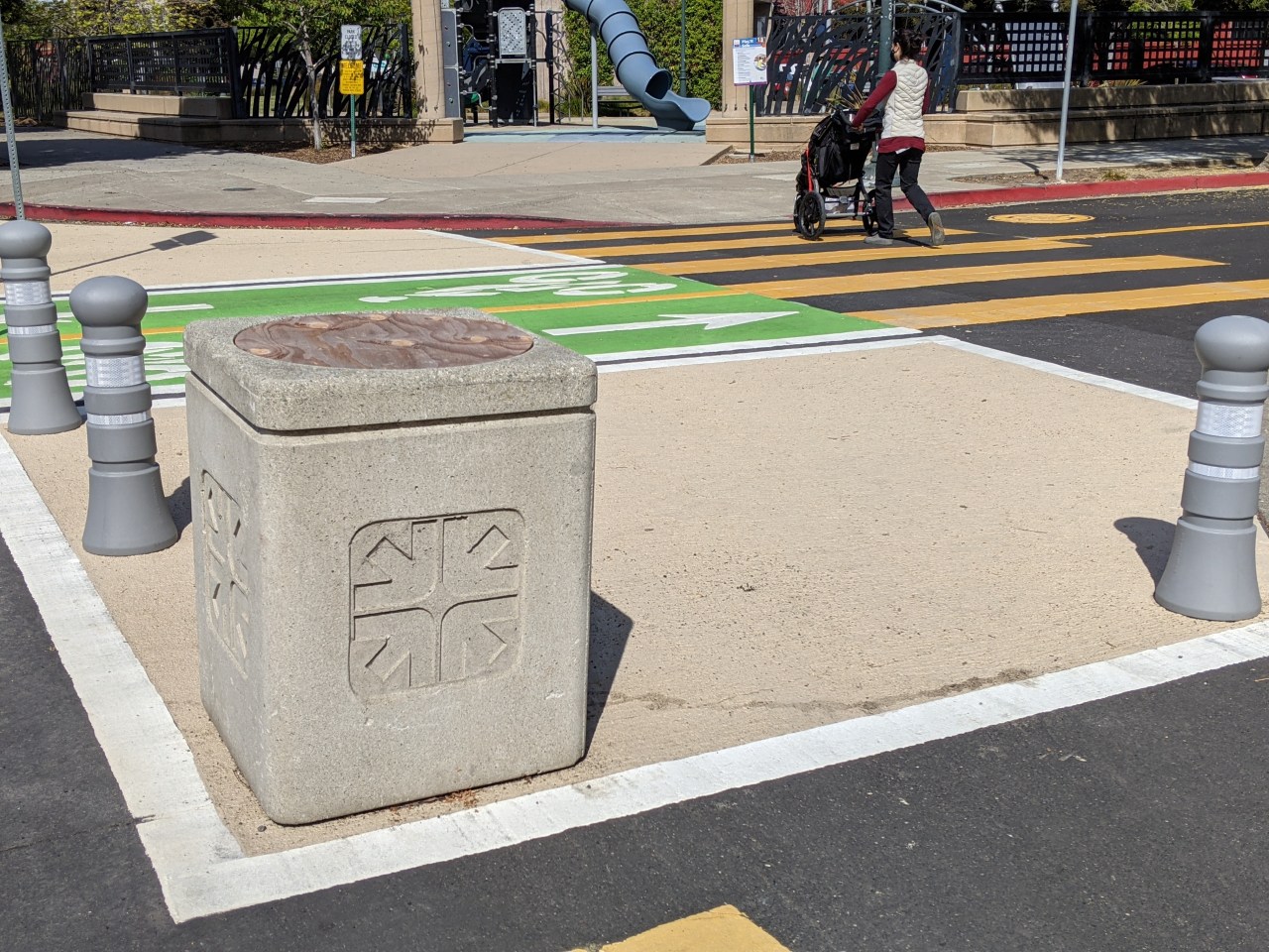 Emeryville shows the way, preventing people from parking on a corner on Doyle Street with a combo of concrete trash cans and plastic posts painted to look like concrete. Photo: Streetsblog/Rudick