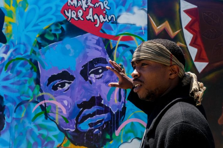 Stevante Clark, an activist whose unarmed brother Stephon Clark was gunned down by Sacramento police in 2018, speaks in front of a mural. Since his brother’s murder, Stevante has led numerous protests in his hometown and was even instrumental in working alongside Governor Gavin Newsom to establish the Stephon Clark law, which changed the standard for when law enforcement can use deadly force. | Photo by Camille Cohen