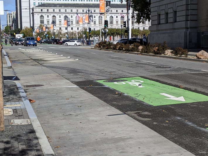 In the left of the pic are portions of the unprotected bike lane and mixing zone that were removed by crews in prep for a protected lane. Photo: Streetsblog/Rudick